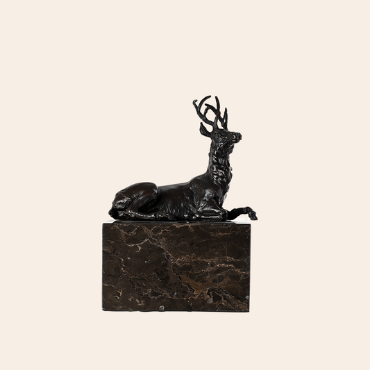 BRONZE SITTING DEER ON GRANITE